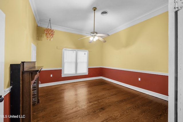 interior space featuring crown molding, visible vents, wood finished floors, baseboards, and a ceiling fan