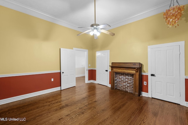interior space with baseboards, ornamental molding, ceiling fan, and wood finished floors