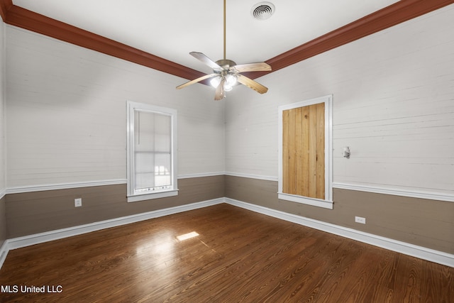 empty room with baseboards, ceiling fan, visible vents, and wood finished floors