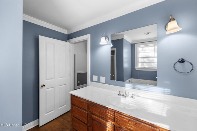 bathroom with vanity, ornamental molding, and wood finished floors
