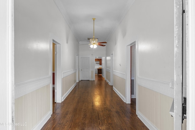 corridor featuring crown molding, wainscoting, and wood finished floors
