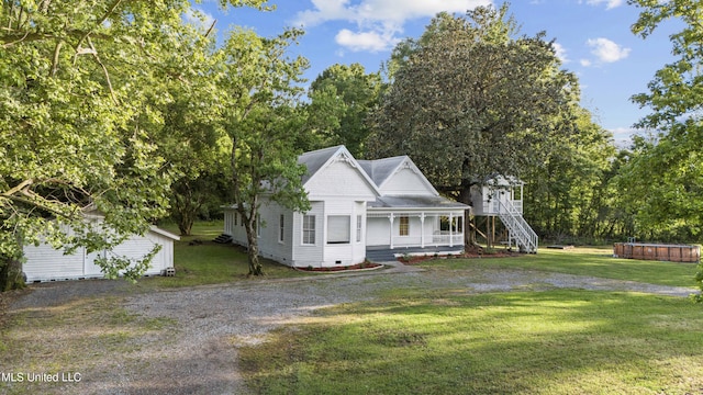 view of front of property with a jacuzzi, a porch, a front lawn, and crawl space