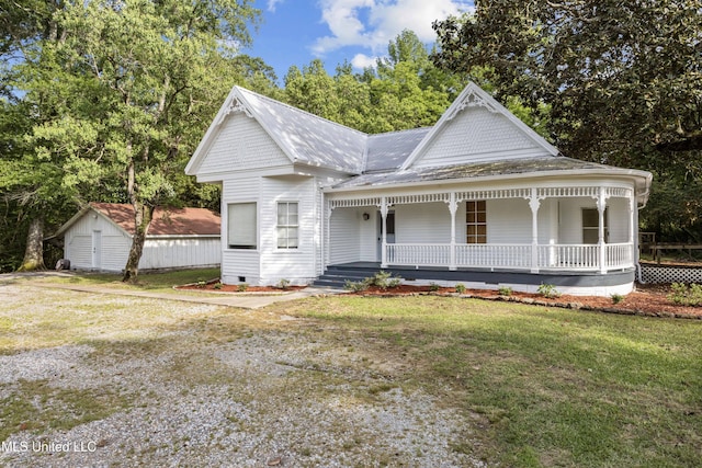 victorian home with a shed, covered porch, crawl space, and a front yard