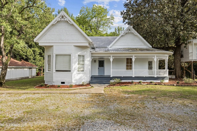 victorian house featuring a porch, a front lawn, and crawl space