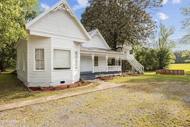victorian home with covered porch, a jacuzzi, a front yard, and crawl space