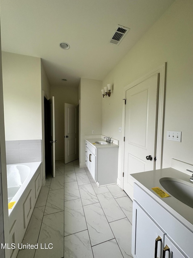 8 Shade Tree Dr, Carriere, MS 39426 - bathroom with marble finish floors, two vanities, a garden tub, and recessed lighting