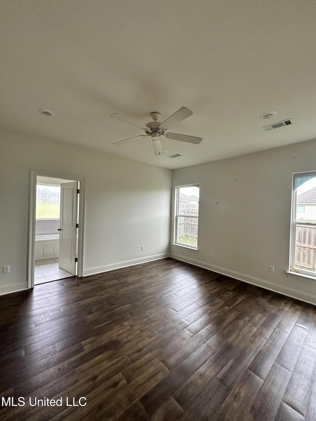 8 Shade Tree Dr, Carriere, MS 39426 - spare room with healthy amount of natural light, a ceiling fan, dark wood-style flooring, and baseboards