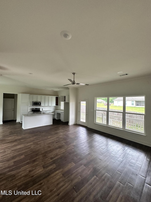 8 Shade Tree Dr, Carriere, MS 39426 - unfurnished living room featuring dark wood-style floors and baseboards