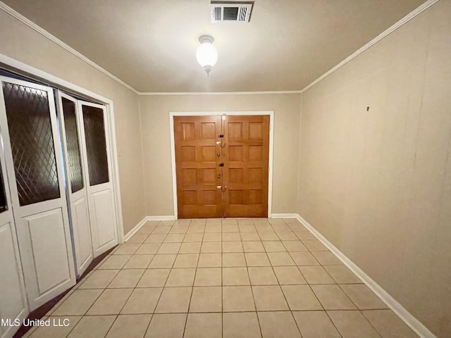 doorway to outside with crown molding and light tile patterned flooring