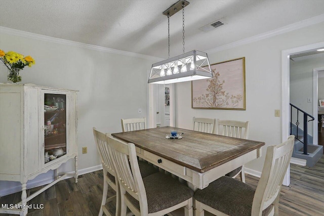 dining space featuring crown molding, dark hardwood / wood-style floors, and a textured ceiling