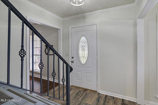 foyer with crown molding, a textured ceiling, and dark hardwood / wood-style flooring