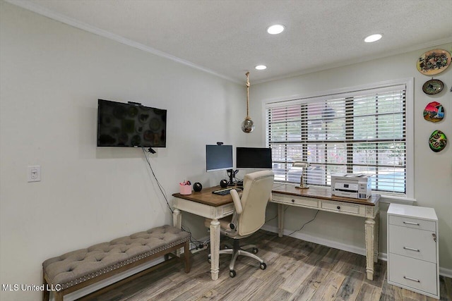 office featuring ornamental molding, a textured ceiling, and hardwood / wood-style flooring