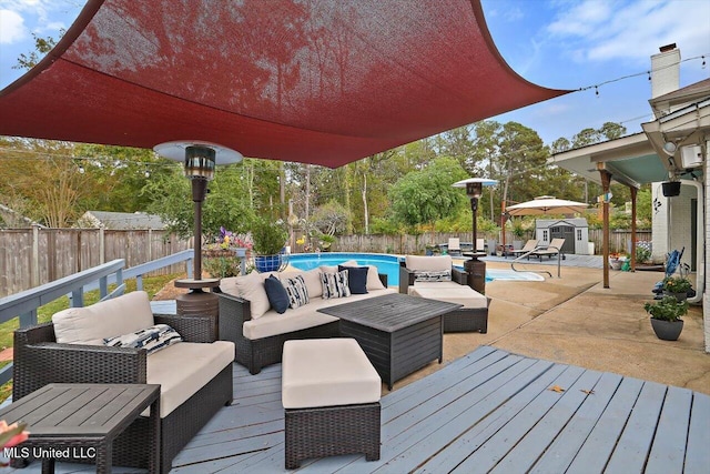 deck with a fenced in pool and an outdoor hangout area