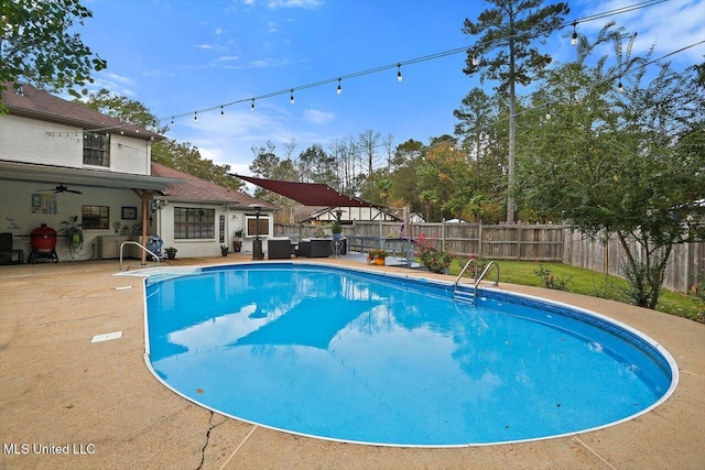 view of pool with a patio and ceiling fan