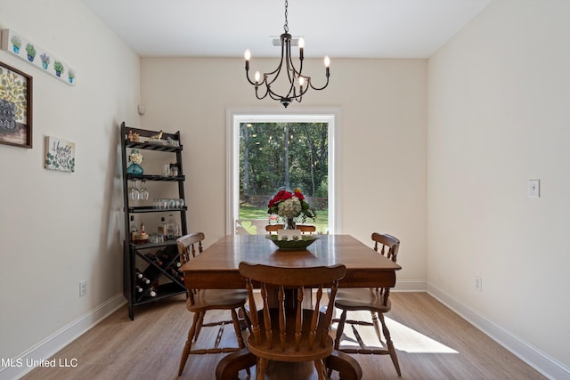 dining area featuring a chandelier and light wood-type flooring