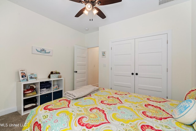 carpeted bedroom featuring a closet and ceiling fan