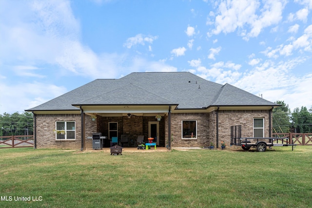 rear view of house with a patio and a yard