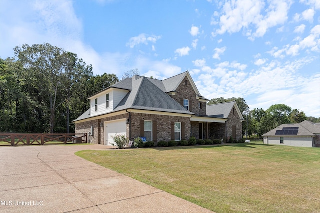 view of front of property with a front yard and a garage