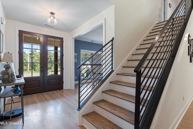 foyer entrance featuring french doors and light wood-type flooring