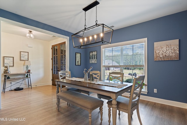 dining area with a chandelier and hardwood / wood-style floors