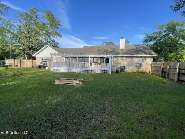 6530 Koula Dr, Diamondhead, MS 39525 - back of house with a chimney, a fenced backyard, and a pergola