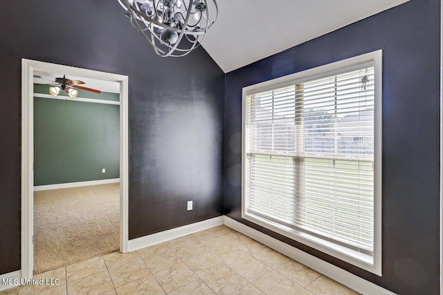 spare room with lofted ceiling, light carpet, baseboards, ceiling fan with notable chandelier, and light tile patterned floors