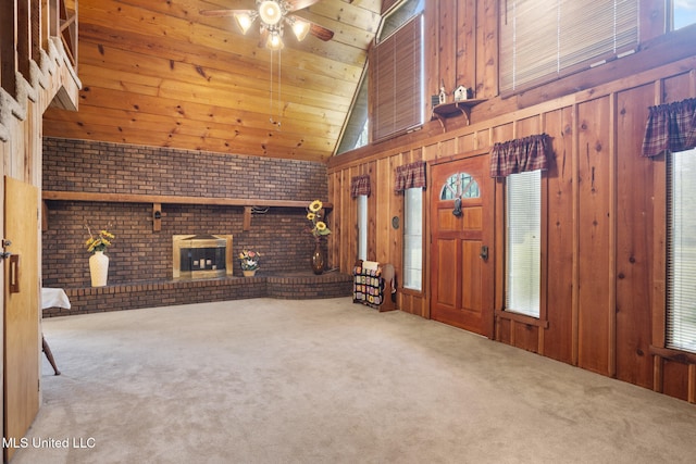 48 Brady Rd, Petal, MS 39465 - unfurnished living room featuring a brick fireplace, carpet, a ceiling fan, wooden walls, and plenty of natural light