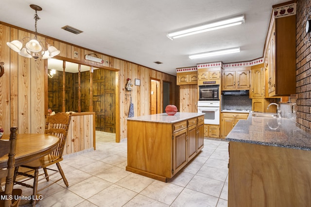 48 Brady Rd, Petal, MS 39465 - kitchen with white oven, wood walls, a center island, black microwave, and dark stone countertops