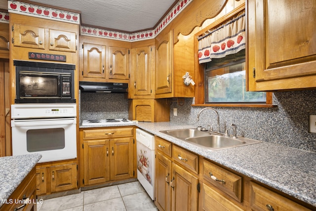 48 Brady Rd, Petal, MS 39465 - kitchen with white appliances, tasteful backsplash, brown cabinetry, exhaust hood, and a textured ceiling