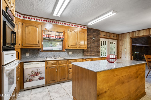 48 Brady Rd, Petal, MS 39465 - kitchen with white appliances, a kitchen island, brown cabinets, light stone counters, and a textured ceiling