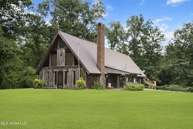 48 Brady Rd, Petal, MS 39465 - back of house featuring a lawn, a chimney, a metal roof, and a standing seam roof