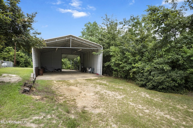 48 Brady Rd, Petal, MS 39465 - view of green lawn featuring a detached carport and driveway