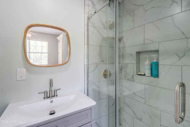 bathroom with a stall shower and vanity