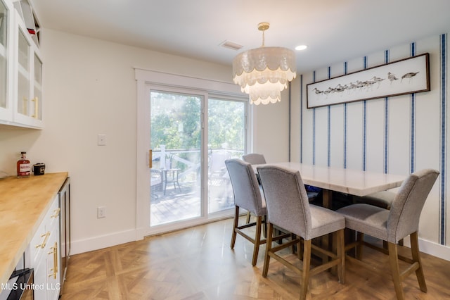 dining space featuring a chandelier, baseboards, and recessed lighting