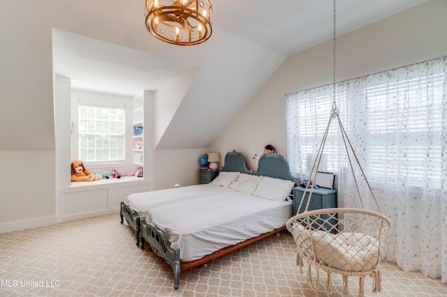 bedroom with lofted ceiling, a chandelier, and carpet flooring