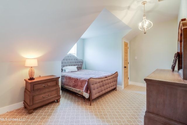 bedroom with lofted ceiling, baseboards, and light colored carpet
