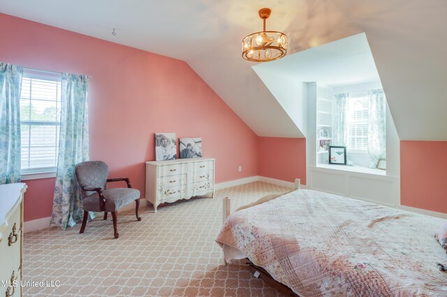 carpeted bedroom featuring vaulted ceiling, baseboards, and a chandelier