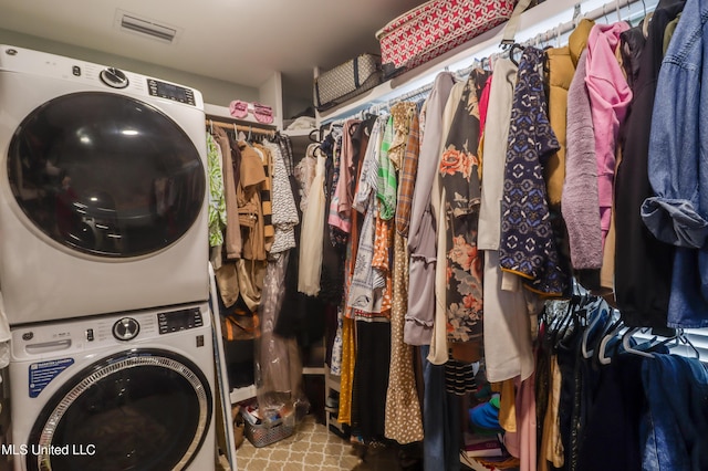 clothes washing area with stacked washer and clothes dryer