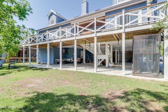 back of property featuring a deck, a yard, a patio, and stairway