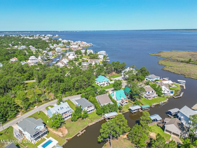 aerial view of residential area featuring a nearby body of water