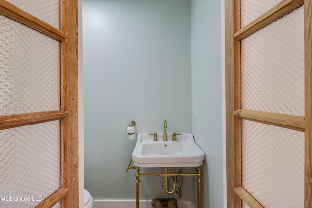 half bath with toilet and a sink