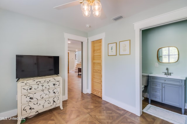 bedroom featuring baseboards and a sink