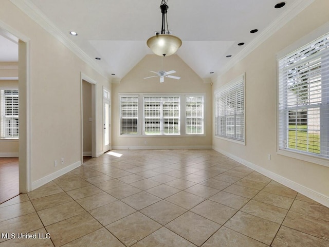 empty room featuring ceiling fan, ornamental molding, vaulted ceiling, and light tile patterned floors