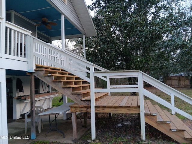 wooden deck with ceiling fan and a patio