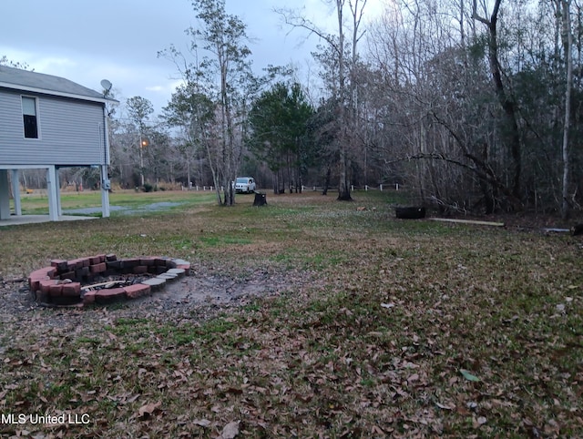 view of yard with an outdoor fire pit