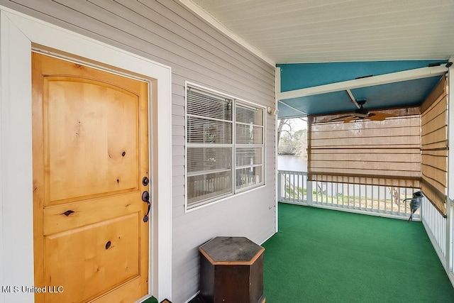 entrance to property featuring ceiling fan and covered porch