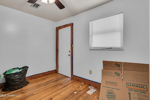 empty room with baseboards, ceiling fan, and hardwood / wood-style flooring