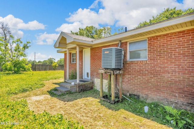 view of front of property with brick siding and cooling unit