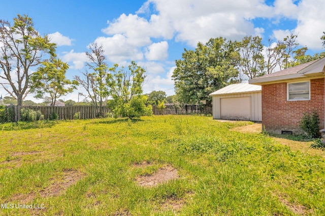 view of yard with fence and an outdoor structure
