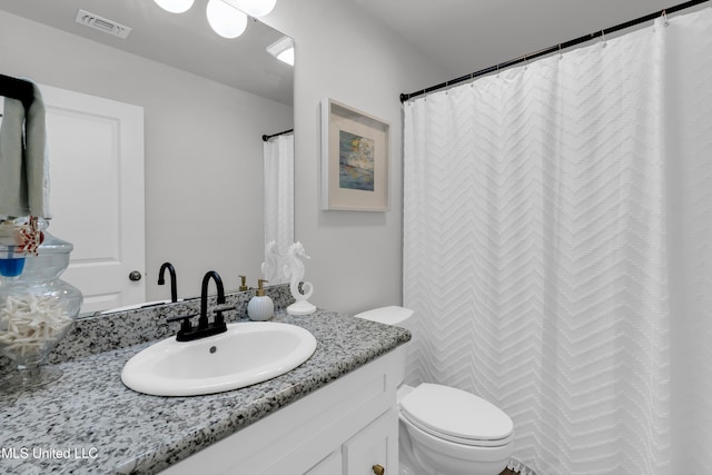 bathroom featuring toilet and vanity